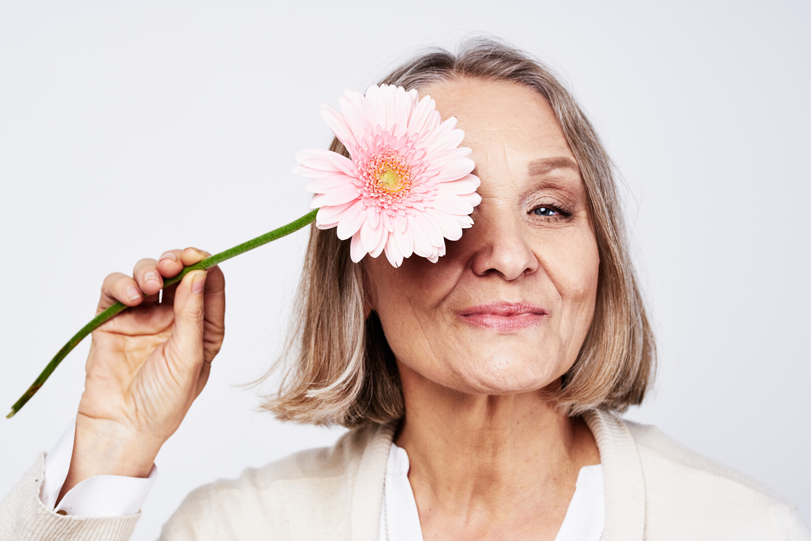 Elderly Woman in White Robe Flower Care Holiday